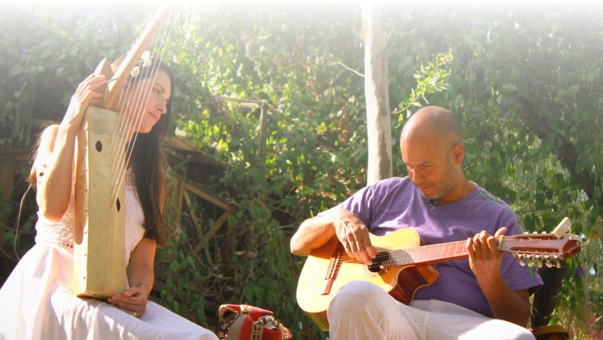 German and Lupita performing medicine music together as Ayahuapu, playing harp and guitar
